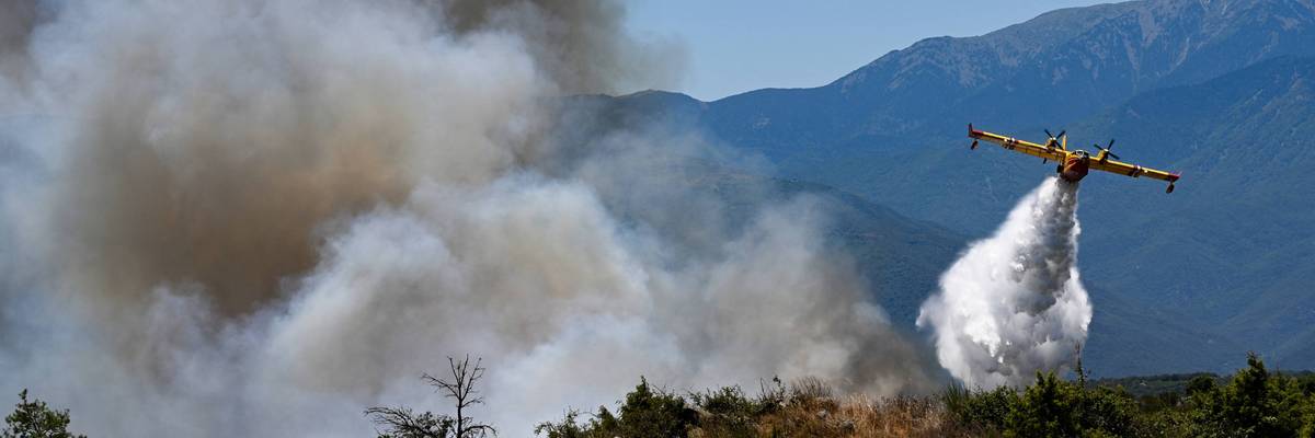 A plane fights a wildfire in France.
