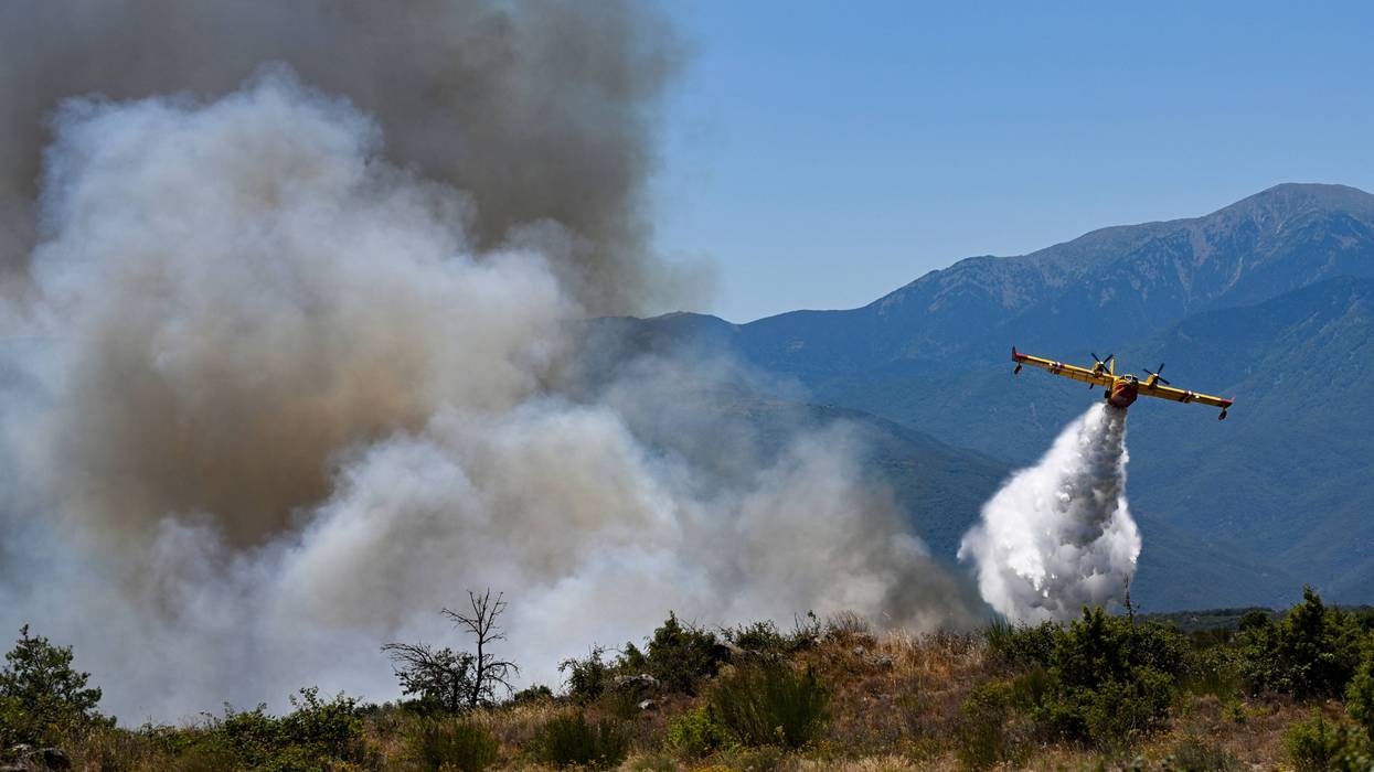 A plane fights a wildfire in France.