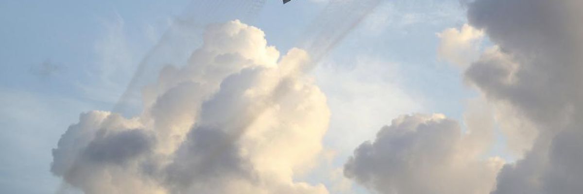 A plane sprays pesticide over the Wynwood neighborhood in the hope of controlling and reducing the number of mosquitos, some of which may be capable of spreading the Zika virus on August 6, 2016 in Miami, Florida.