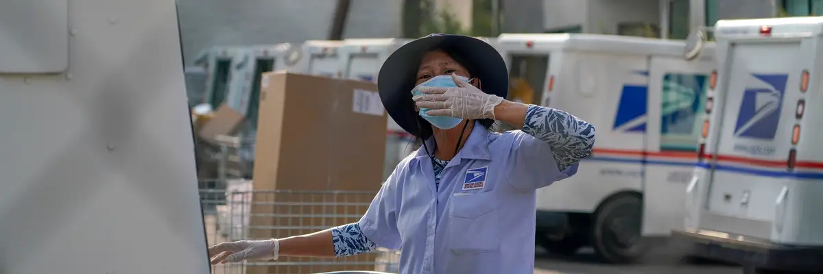 A postal worker blows a kiss.