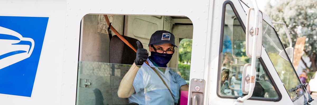 A postal worker gives a thumbs-up to demonstrators protesting the Trump administration's sabotage of the U.S. Postal Service on August 22, 2020 in Los Angeles, California. (Photo: Rich Fury/Getty Images for MoveOn)