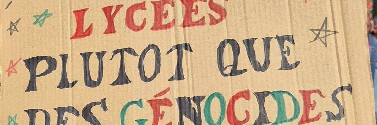 A poster reads, "Fund our high schools instead of genocides," in French.