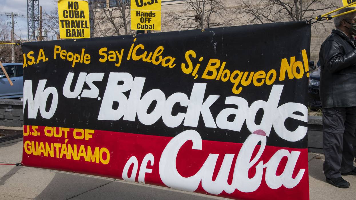 A poster reads, "No US Blockade of Cuba.'
