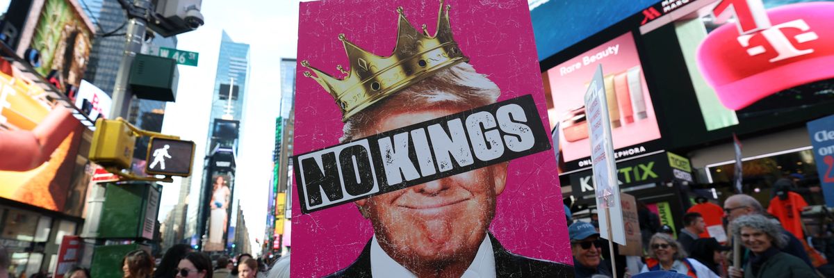 A poster says No Kings over an image of Trump wearing a crown.
