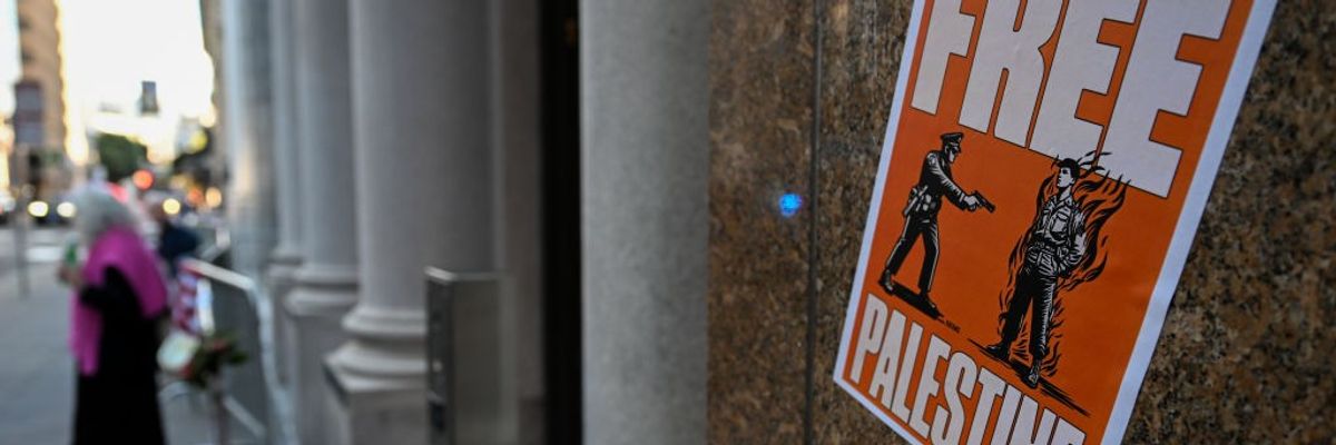 A poster shows Aaron Bushnell's last moments with the words Free Palestine.