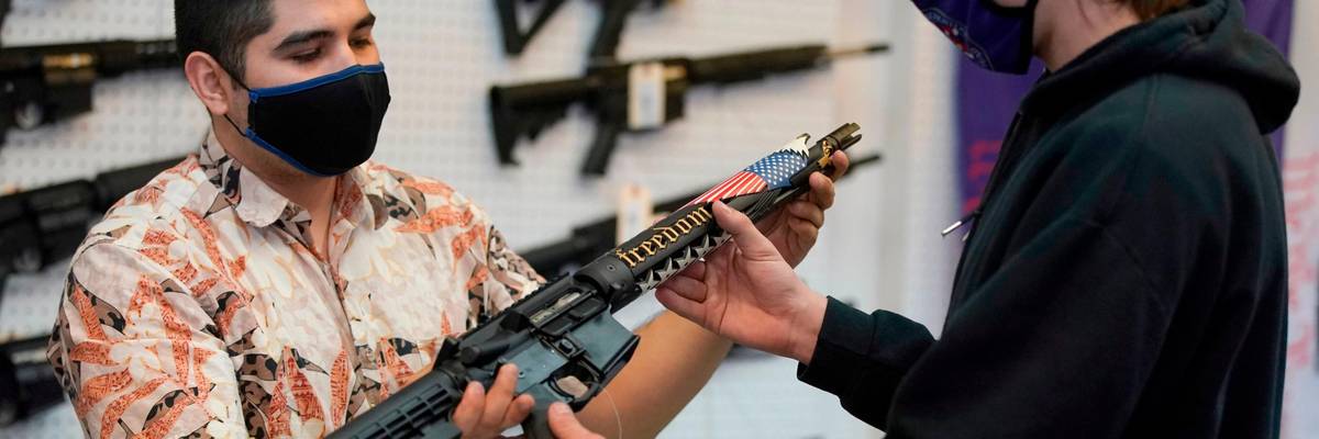 A potential customer checks out an AR-15-style rifle