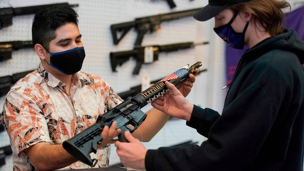 A potential customer checks out an AR-15-style rifle