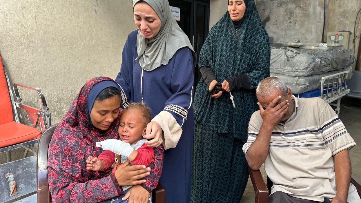 A pregnant woman mourns her husband's death in an Israeli attack in Rafah, Gaza