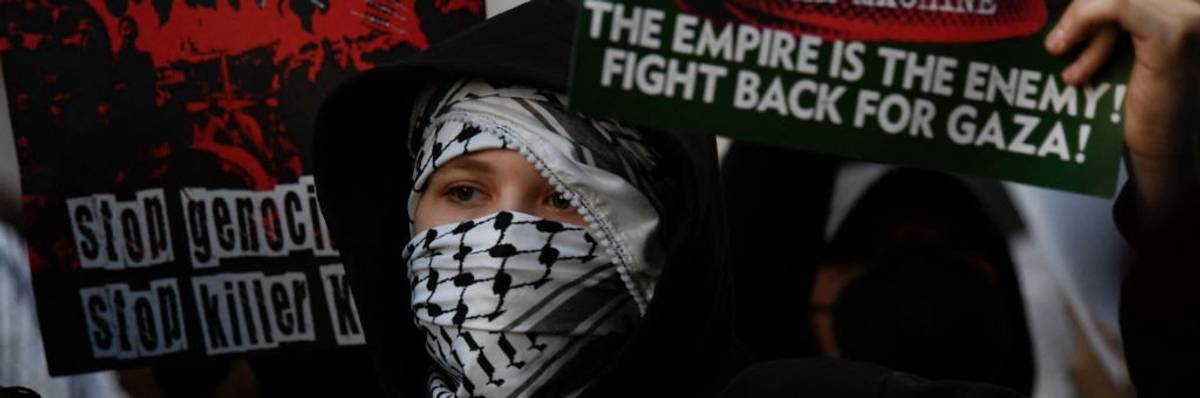 A pro-Palestine protester in a keffiyeh demonstrates outside the DNC in Chicago