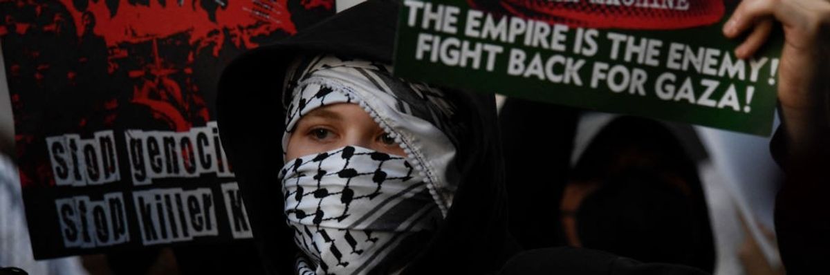 A pro-Palestine protester in a keffiyeh demonstrates outside the DNC in Chicago