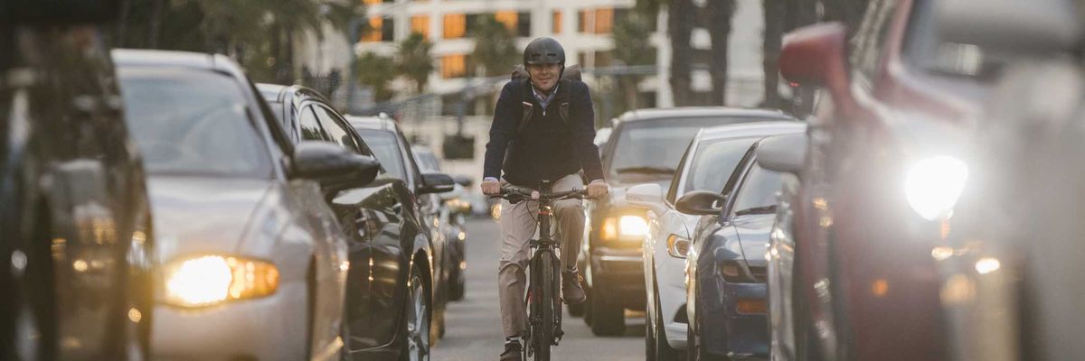 A professional man electric bicycle ebike commuting to work through the traffic of San Diego, California, USA.