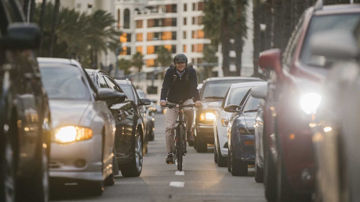 A professional man electric bicycle ebike commuting to work through the traffic of San Diego, California, USA.