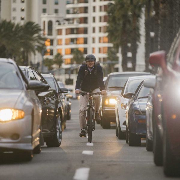 A professional man electric bicycle ebike commuting to work through the traffic of San Diego, California, USA.