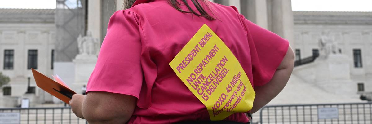 A proponent of student debt forgiveness demonstrates outside the U.S. Supreme Court