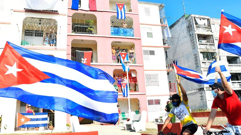 A protest against the U.S. embargo on Cuba with Cuban flags.