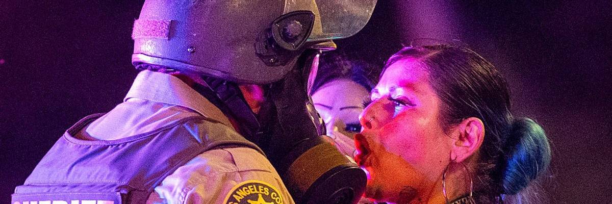 A protester comes face to face with a sheriff deputy.