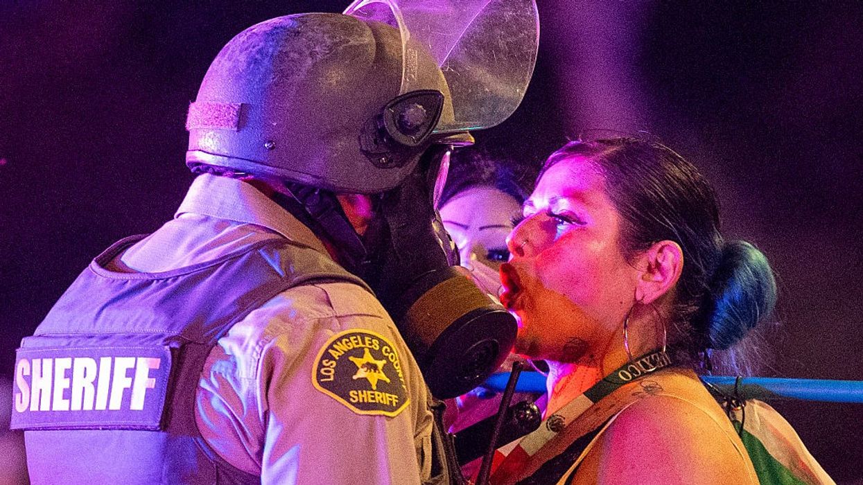 A protester comes face to face with a sheriff deputy.