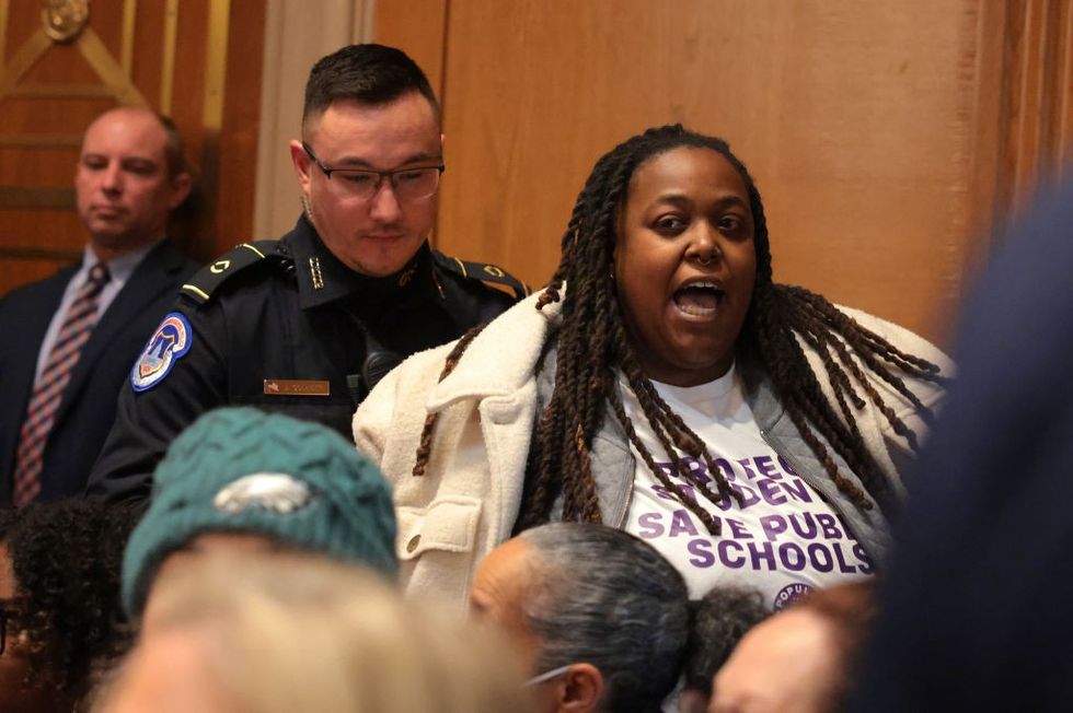 A protester disrups of the Senate confirmation hearing for Linda McMahon