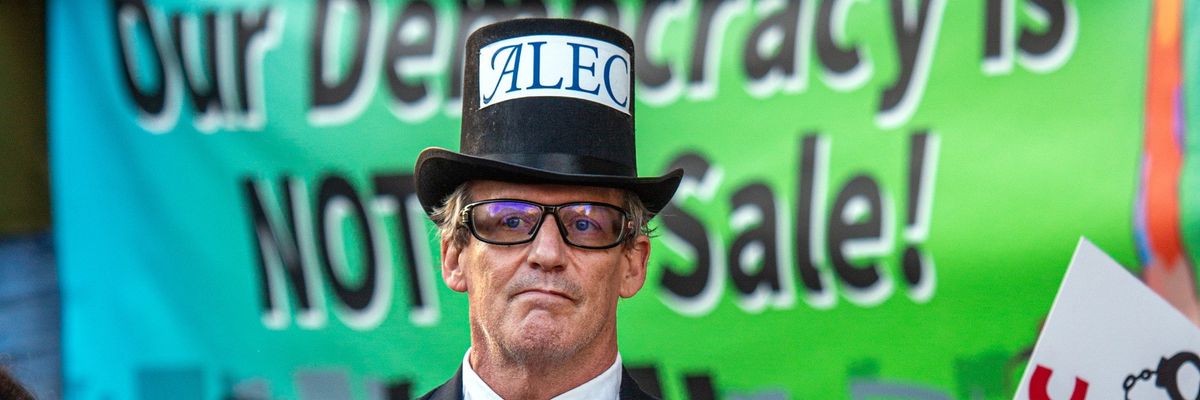 A protester dressed as the manifestation of ALEC.