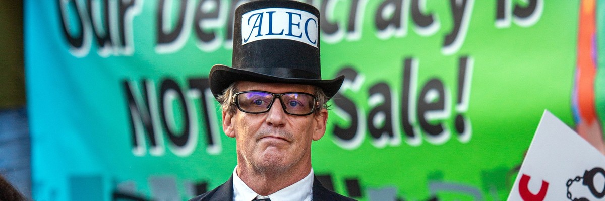 A protester dressed as the manifestation of ALEC.