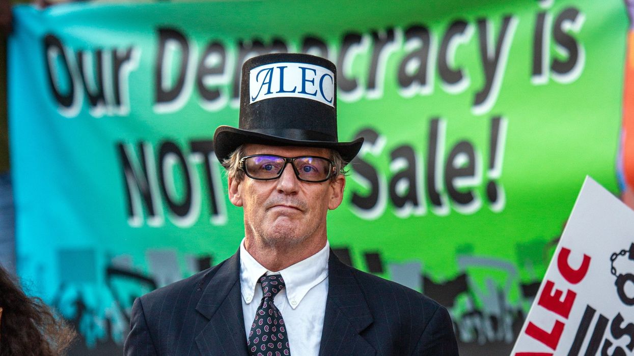 A protester dressed as the manifestation of ALEC.