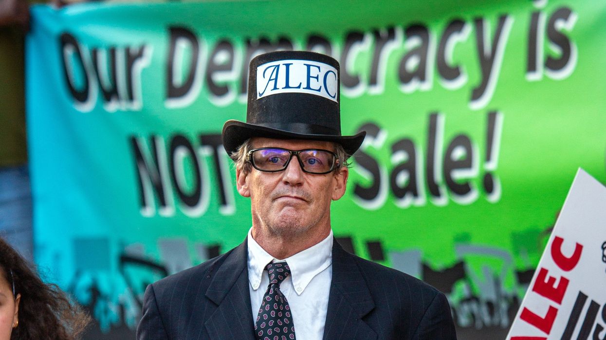 A protester dressed as the manifestation of ALEC.