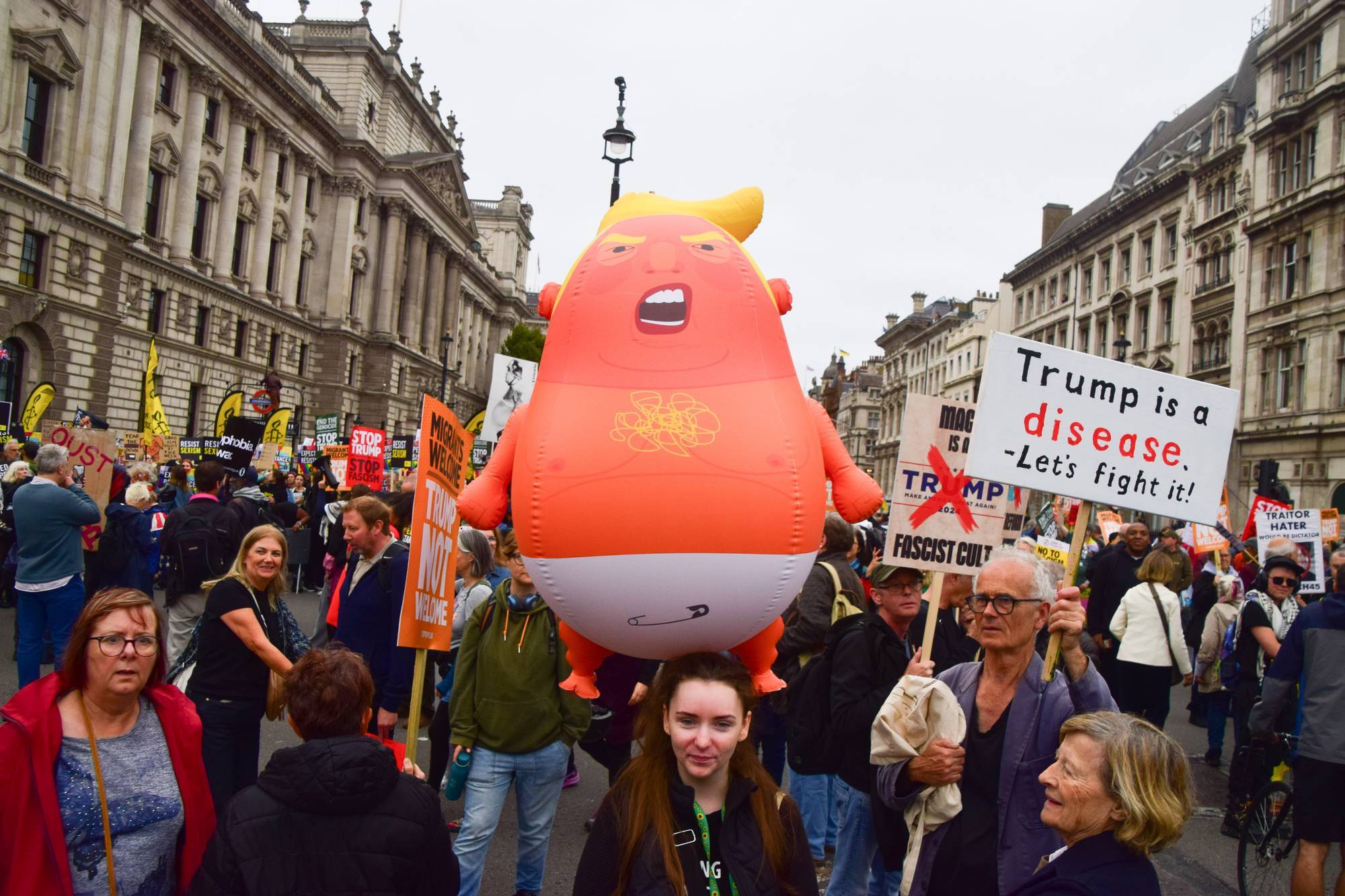 A protester holds a Baby Trump balloon during the