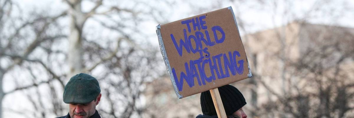 A protester holds a placard during the nationwide "Stop ICE...