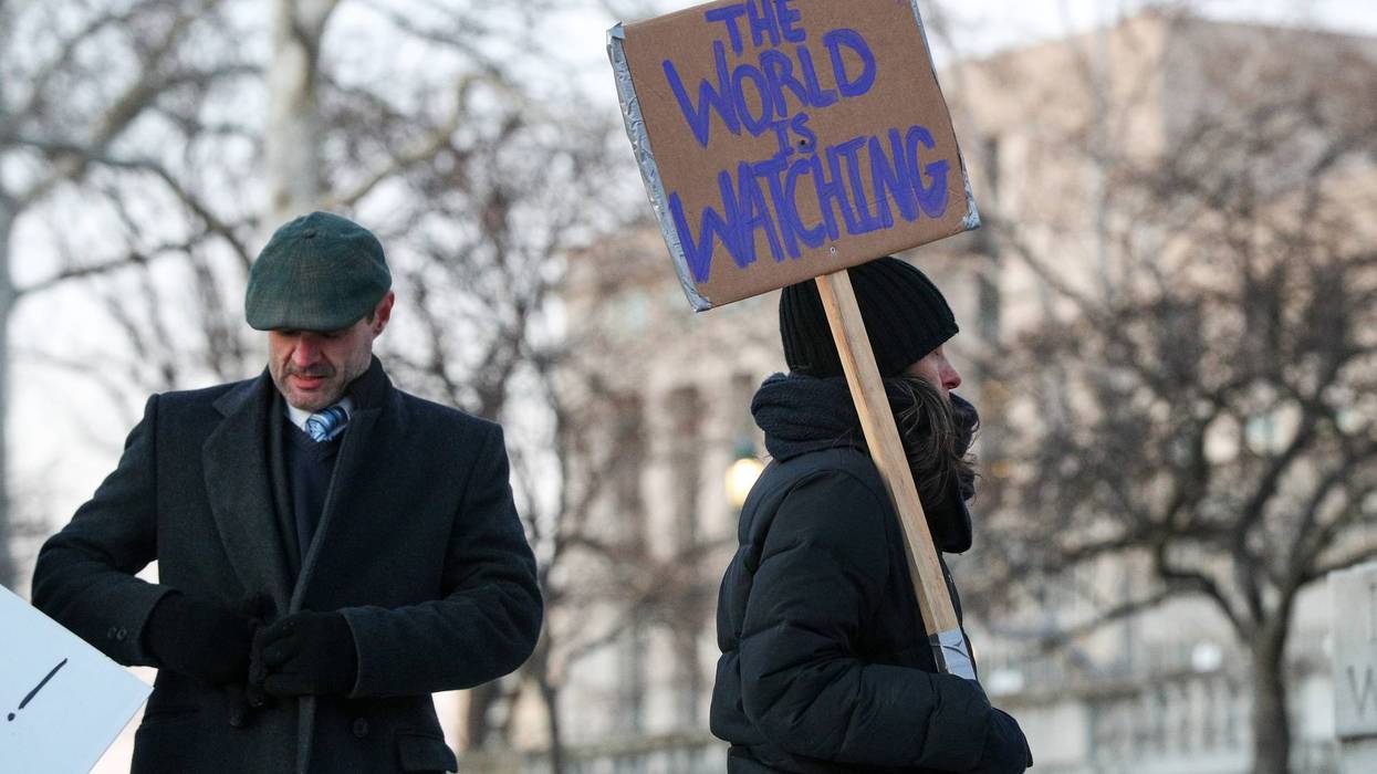 A protester holds a placard during the nationwide "Stop ICE...