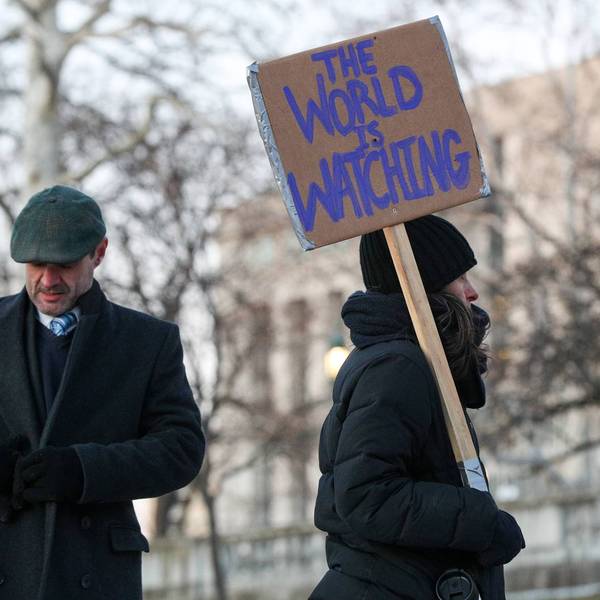 A protester holds a placard during the nationwide "Stop ICE...