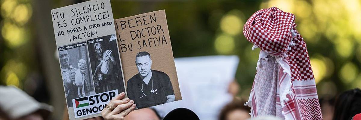 A protester holds a placard reading "Free the doctor Abu Safiya"