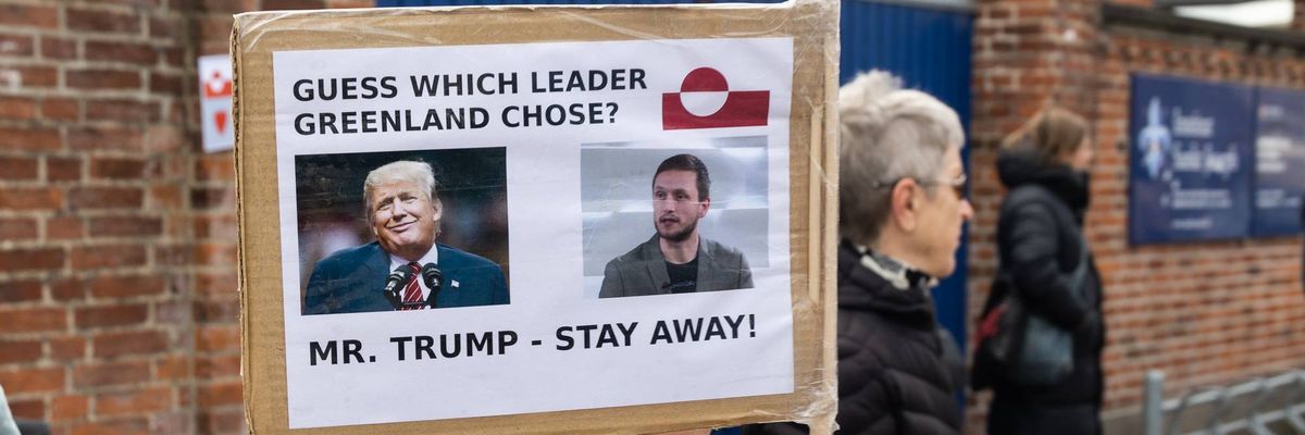 A protester holds a placard with a photo of US President Donald Trump and Greenland's newly elected head of government