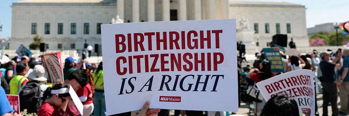 A protester holds a sign reading "birthright citizenship is a right" outside the supreme court