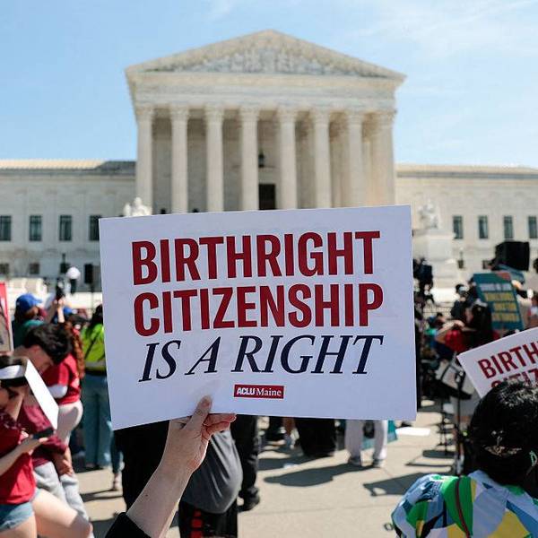 A protester holds a sign reading "birthright citizenship is a right" outside the supreme court