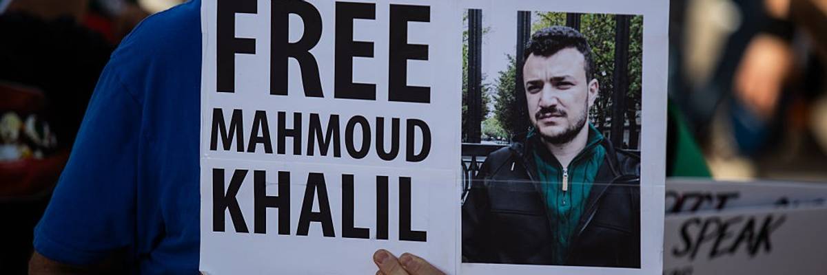 A protester holds a sign reading, "Free Mahmoud Khalil."