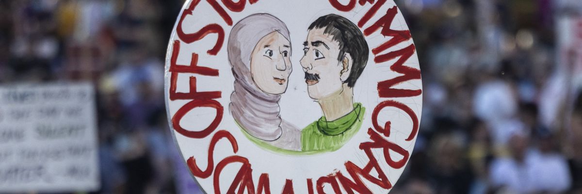 A protester holds a sign reading, "Hands off students and immigrants" during a nationwide protest against U.S. President Donald Trump in Los Angeles on April 5, 2025.