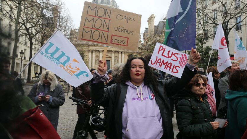 A protester holds a sign that reads ''My body, my uterus, my choice'' in French