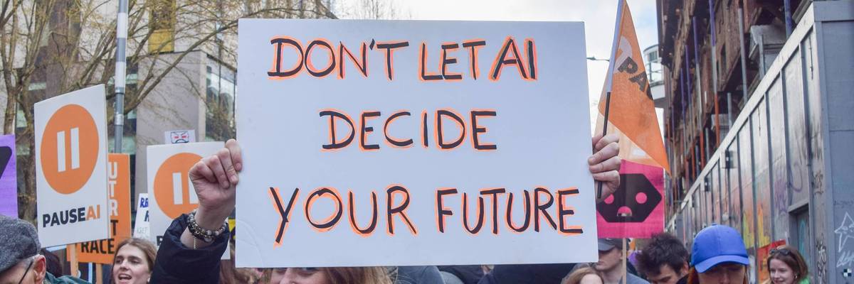 A protester holds an anti-AI placard outside OpenAI offices