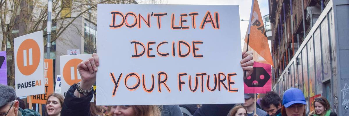 A protester holds an anti-AI placard outside OpenAI offices
