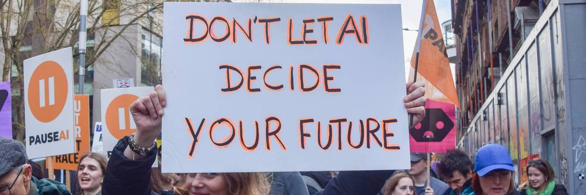 A protester holds an anti-AI placard outside OpenAI offices