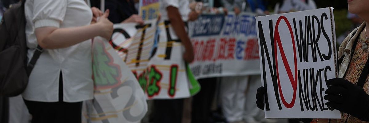A protester holds an anti-war sign at the Hiroshima Peace Memorial Park