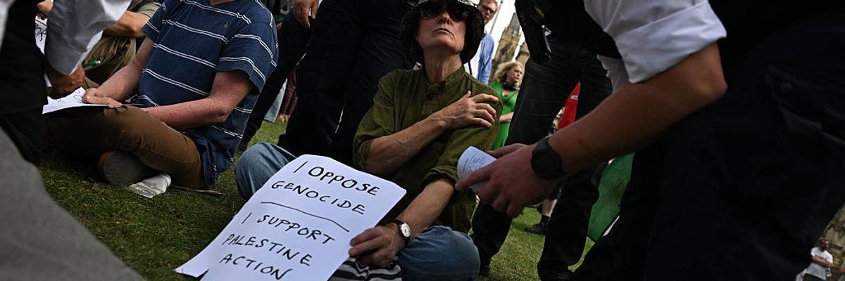 A protester is arrested at a demontration supporting Palestine Action
