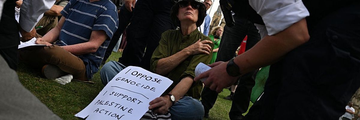 A protester is arrested at a demontration supporting Palestine Action