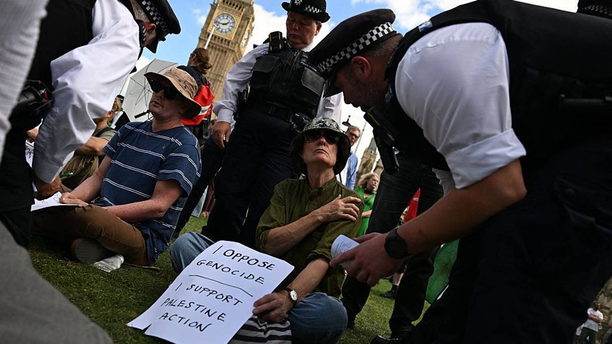 A protester is arrested at a demontration supporting Palestine Action