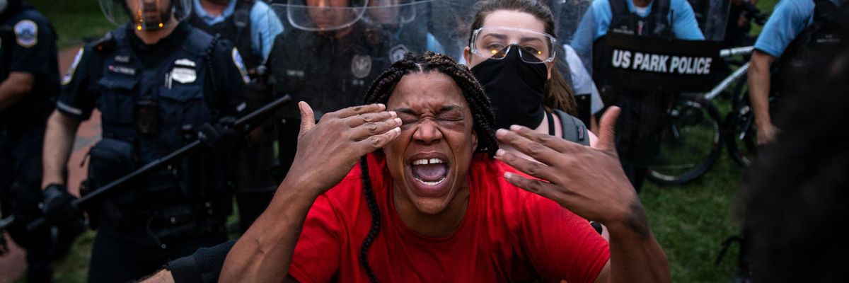 A protester reacts after being hit with tear gas