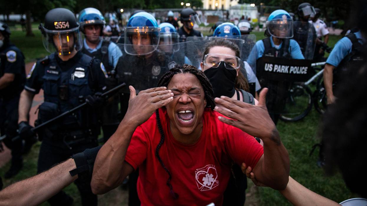 A protester reacts after being hit with tear gas