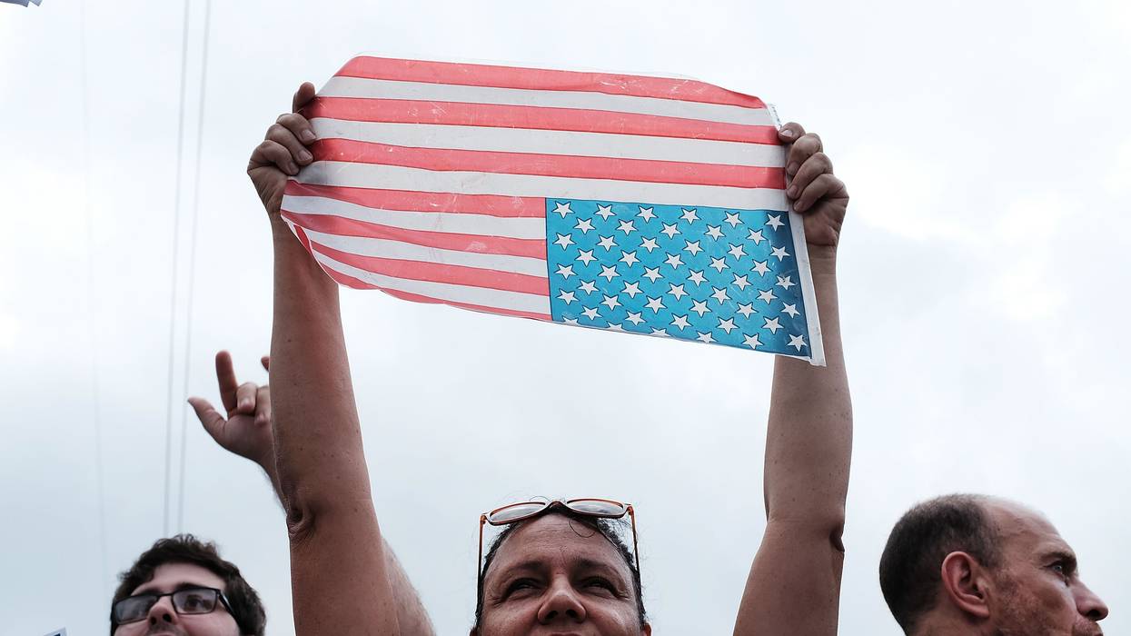 A protester turns an American flag upside down.