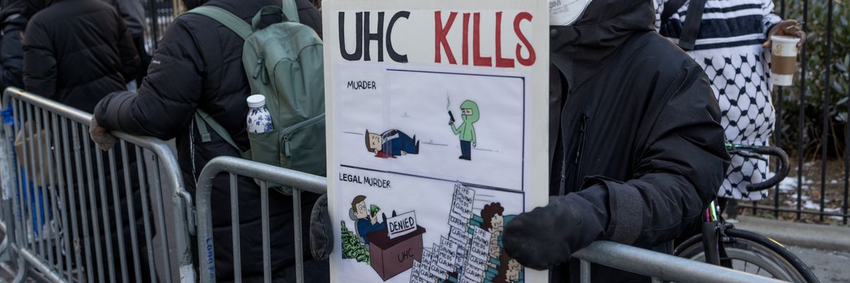 A protestor holds a sign outside of Manhattan Criminal Court