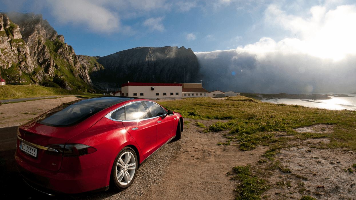 A red Tesla is seen parked in Norway
