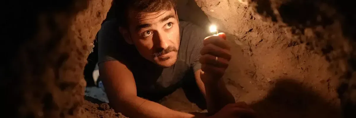 A reenactment from the film Palestinian Prison Break shows a prisoner trying to dig a tunnel out of a facility.